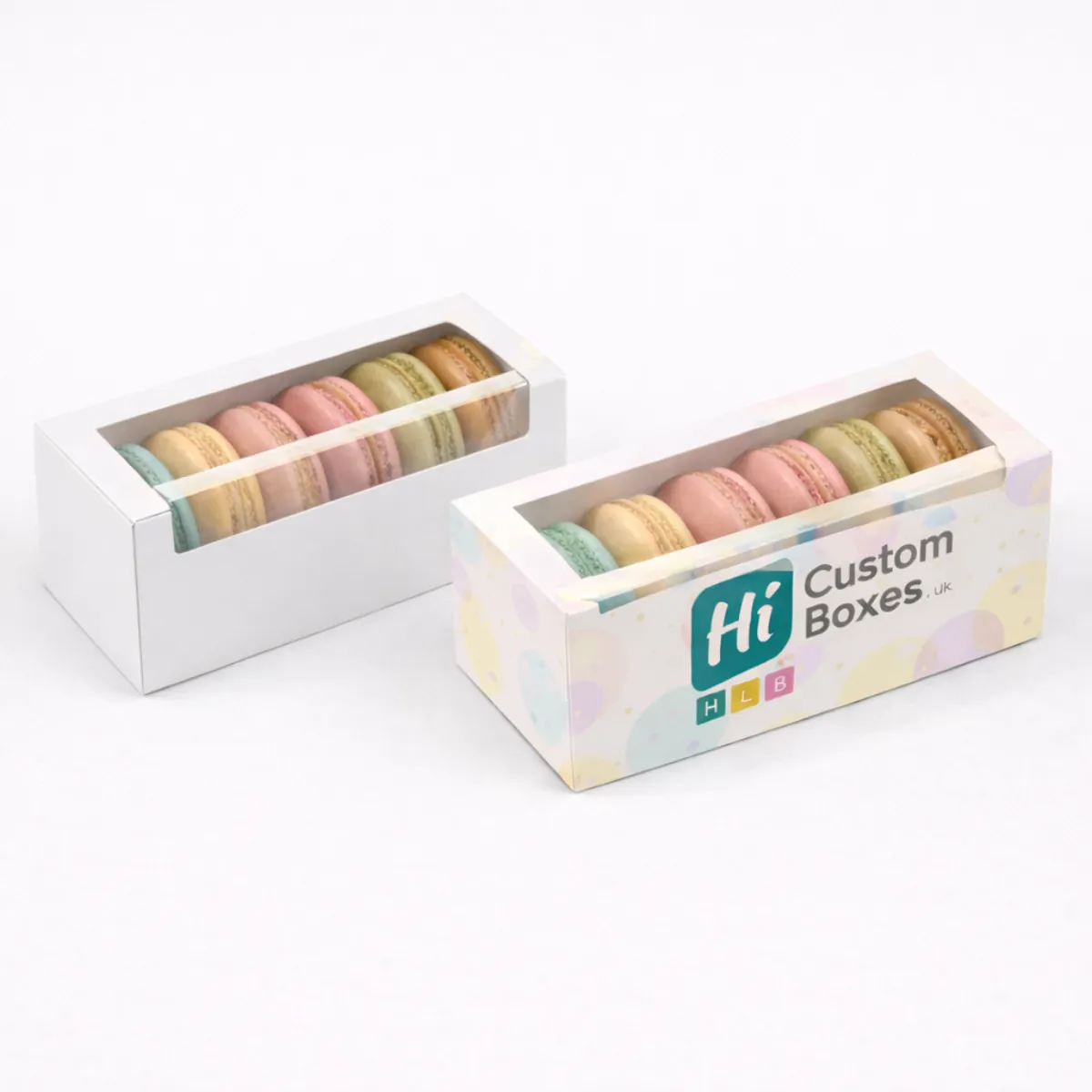 Two rectangular white boxes with clear windows- one plain and one with branded pastel circles- class=